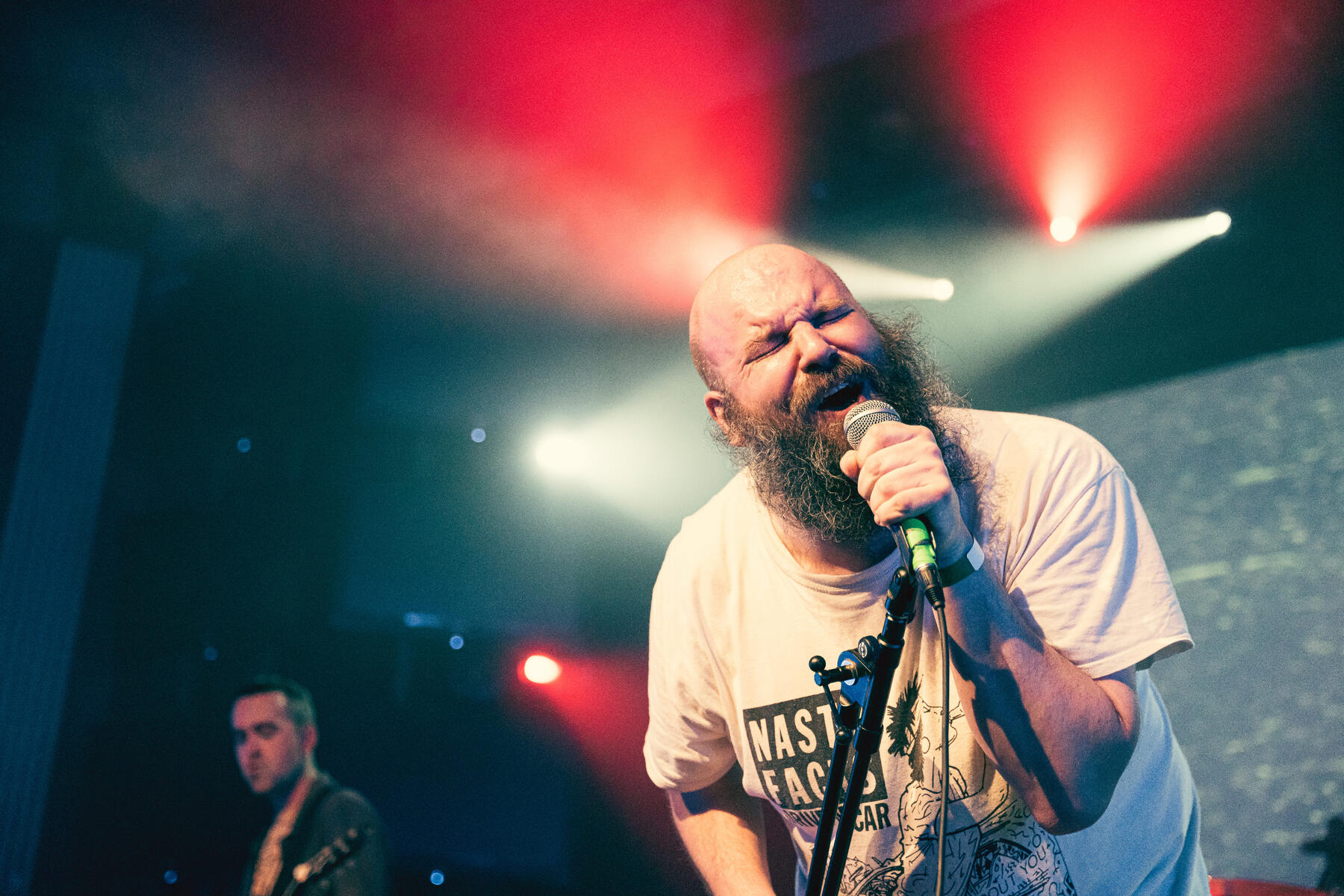 Color photo of band in purple spotlights on stage and crowd. Band is "Born Ruffians"