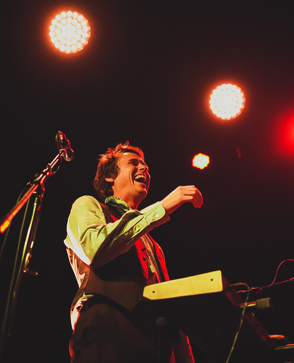 Pianist laughing and smiling while playing on stage. Band is "Basia"