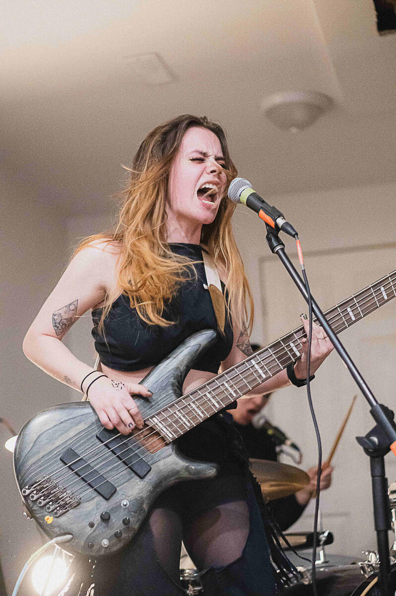 Colored photo of bassist screaming into microphone. Band is &quot;Bodice&quot;