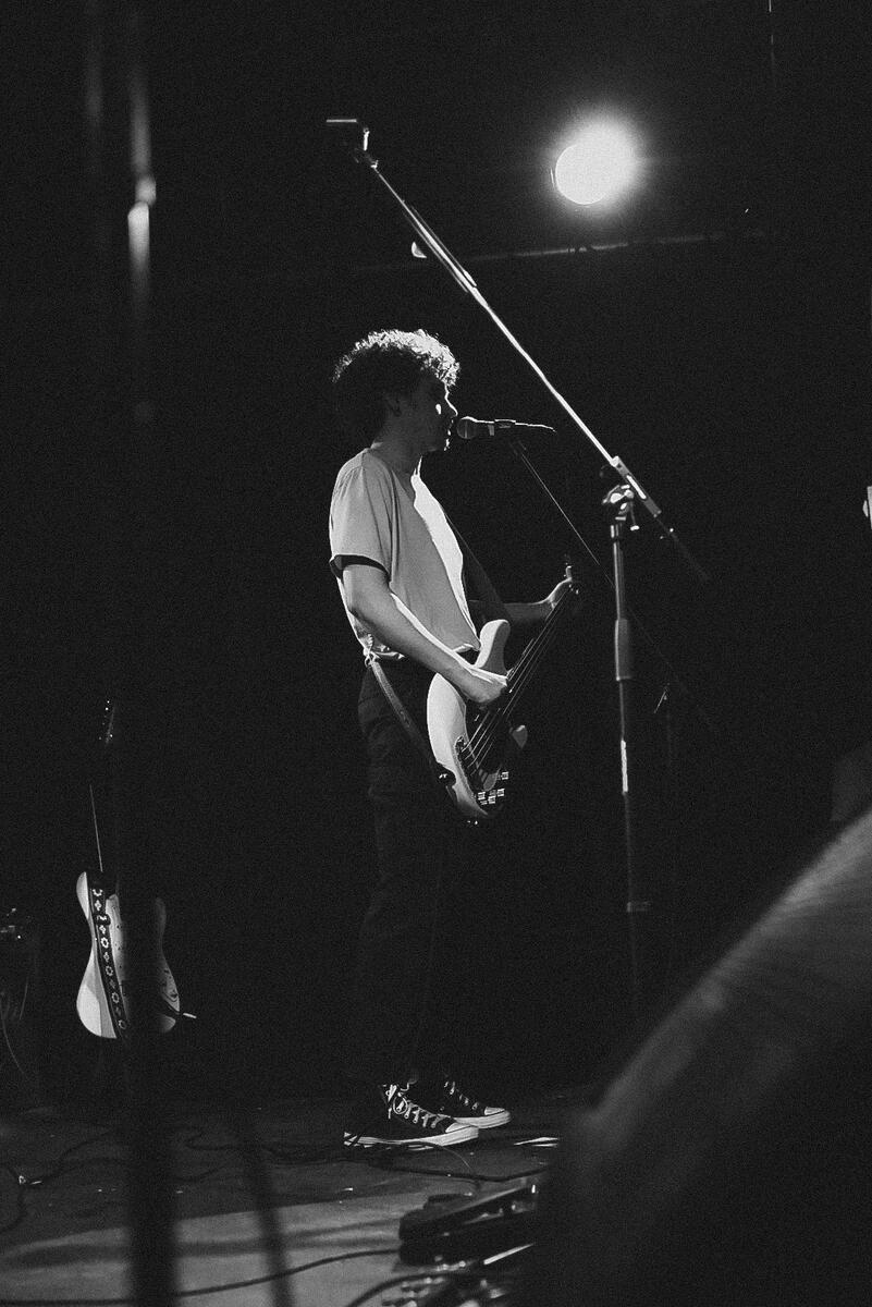 Black and white image of bassist and back up vocalist. Band is "El Paladin"